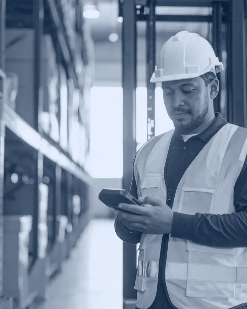 un cariste consulte son terminal mobile ans un entrepôt
